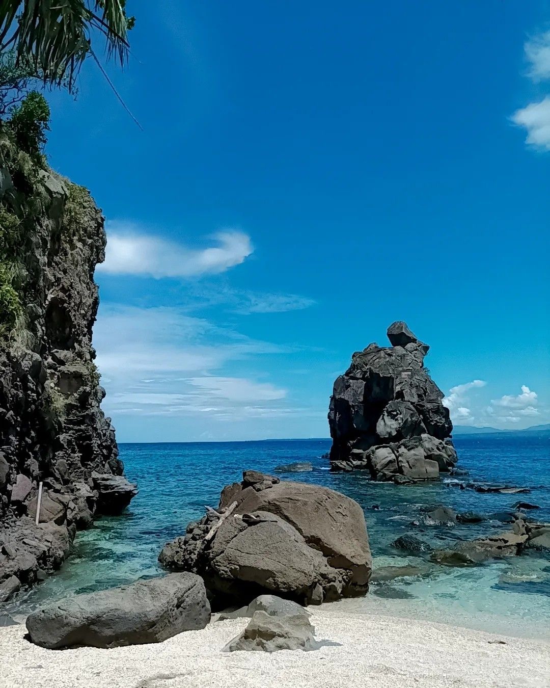Cascading waterfall into a clear blue pool in Leyte forest